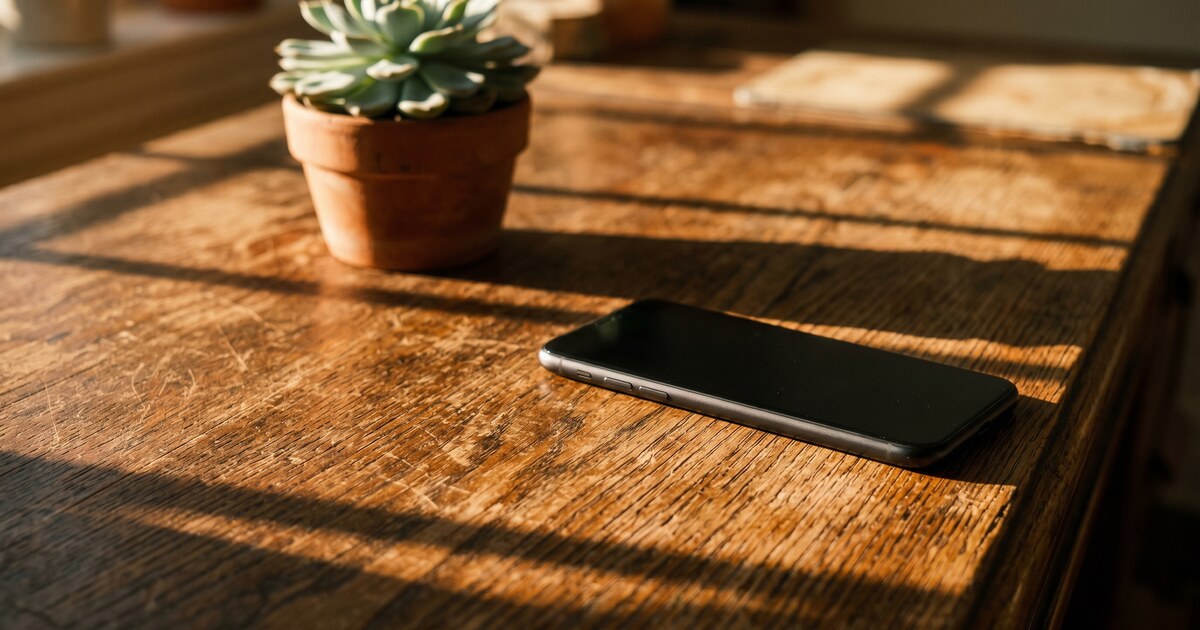 Smartphone showing a log of repeated debt collector calls with a notepad listing dates and times